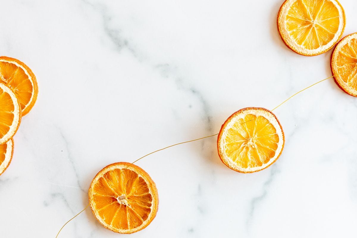 An orange garland laid out on a marble countertop