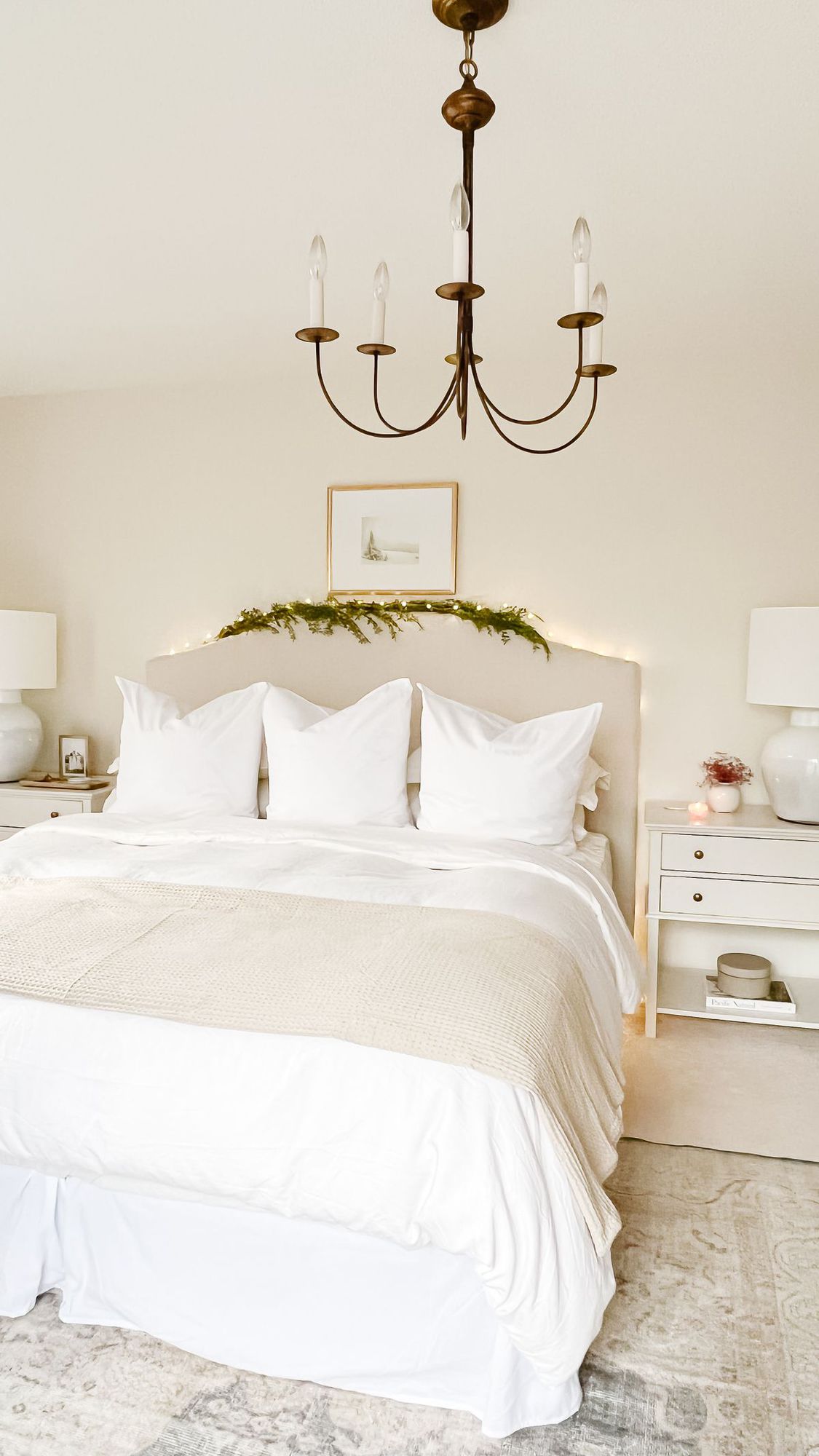 A primary bedroom with a garland and Traditional Christmas decorations