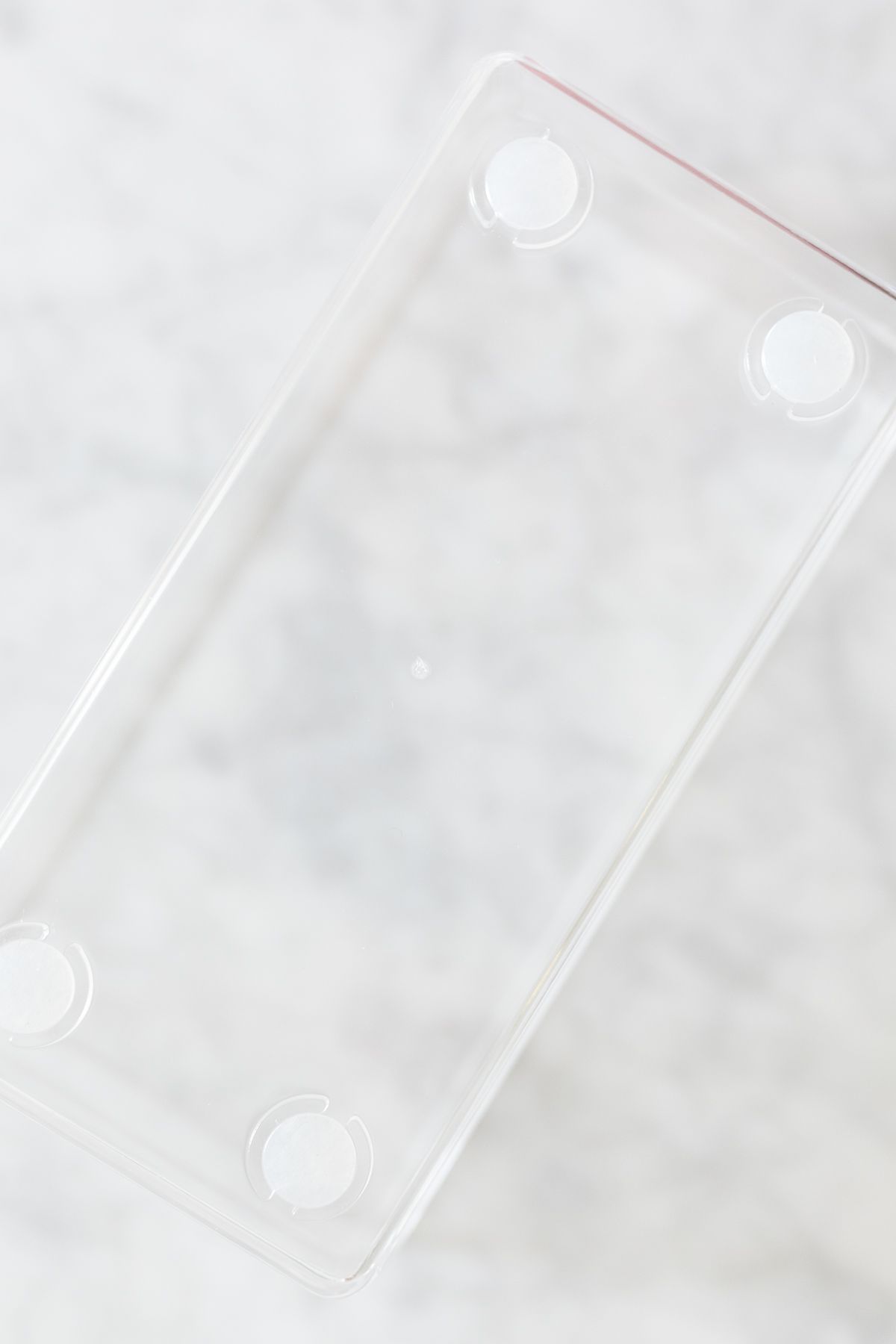 A clear plastic bathroom drawer organizer on a marble surface