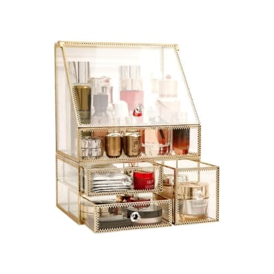 A gold makeup organizer with a plethora of cosmetics inside, perfect for bathroom organization.