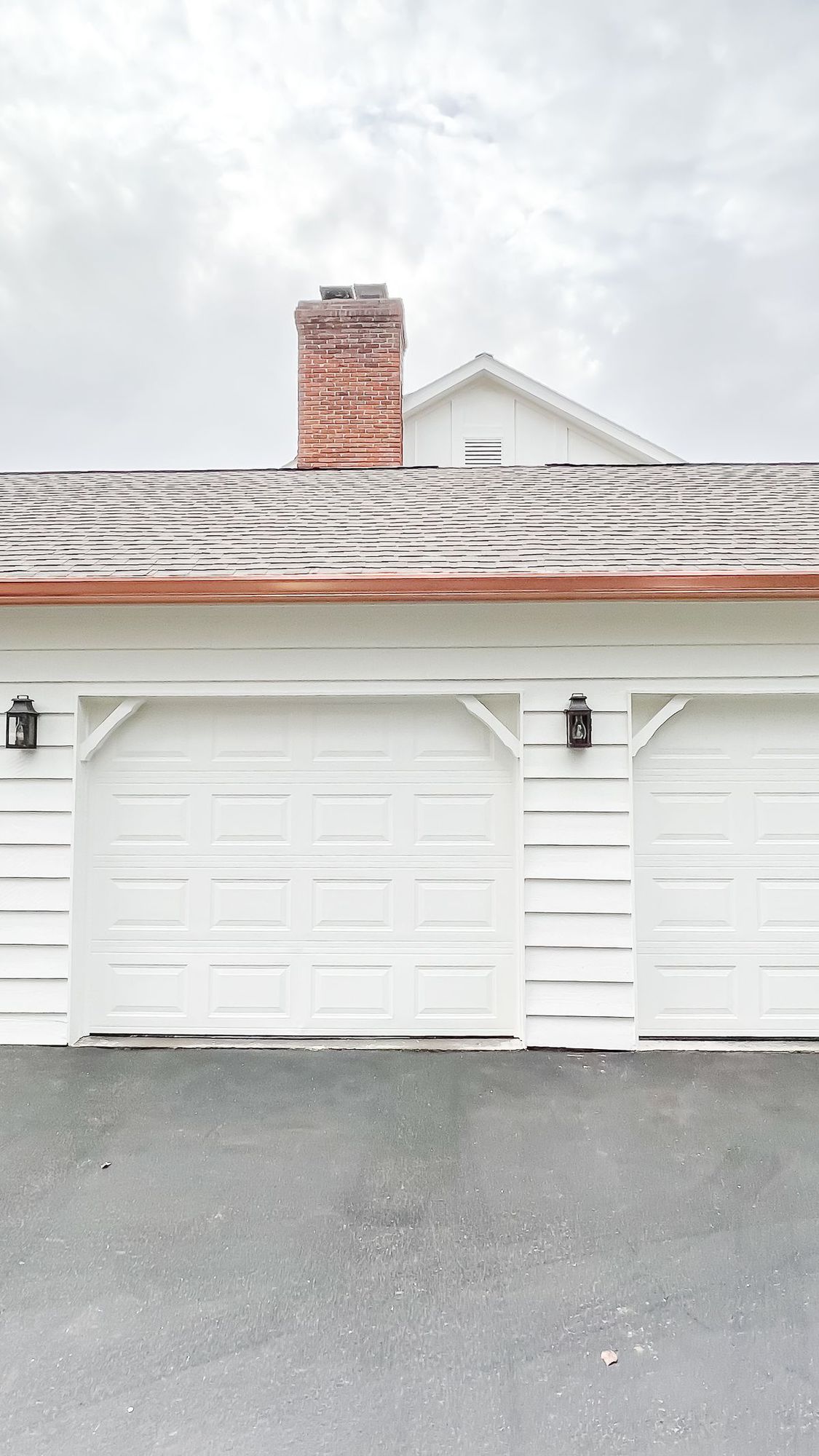 Copper gutters running over a white exterior garage