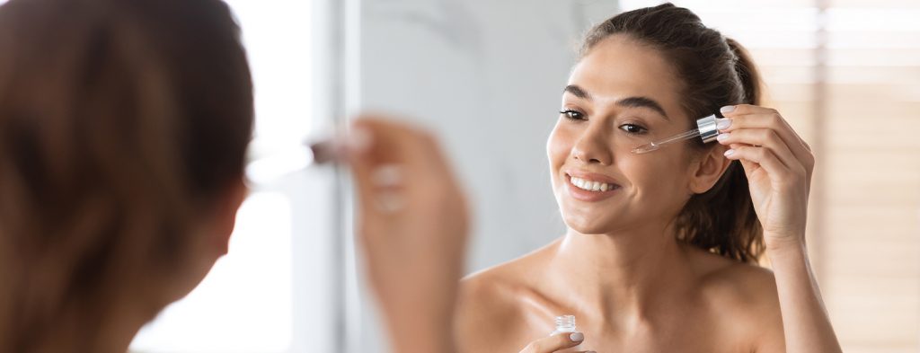 Woman applying serum