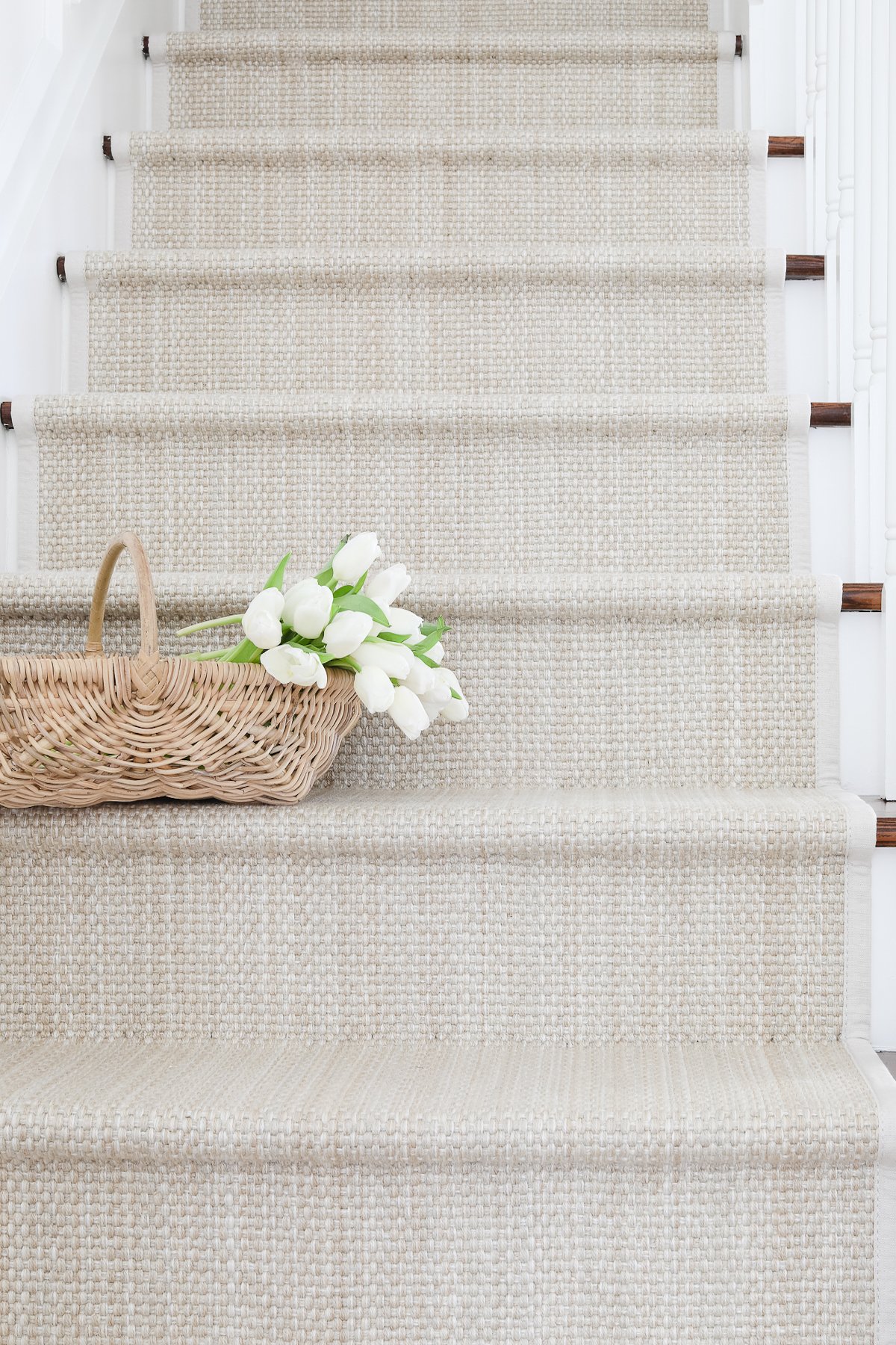 A wooden staircase with a diy stair runner.