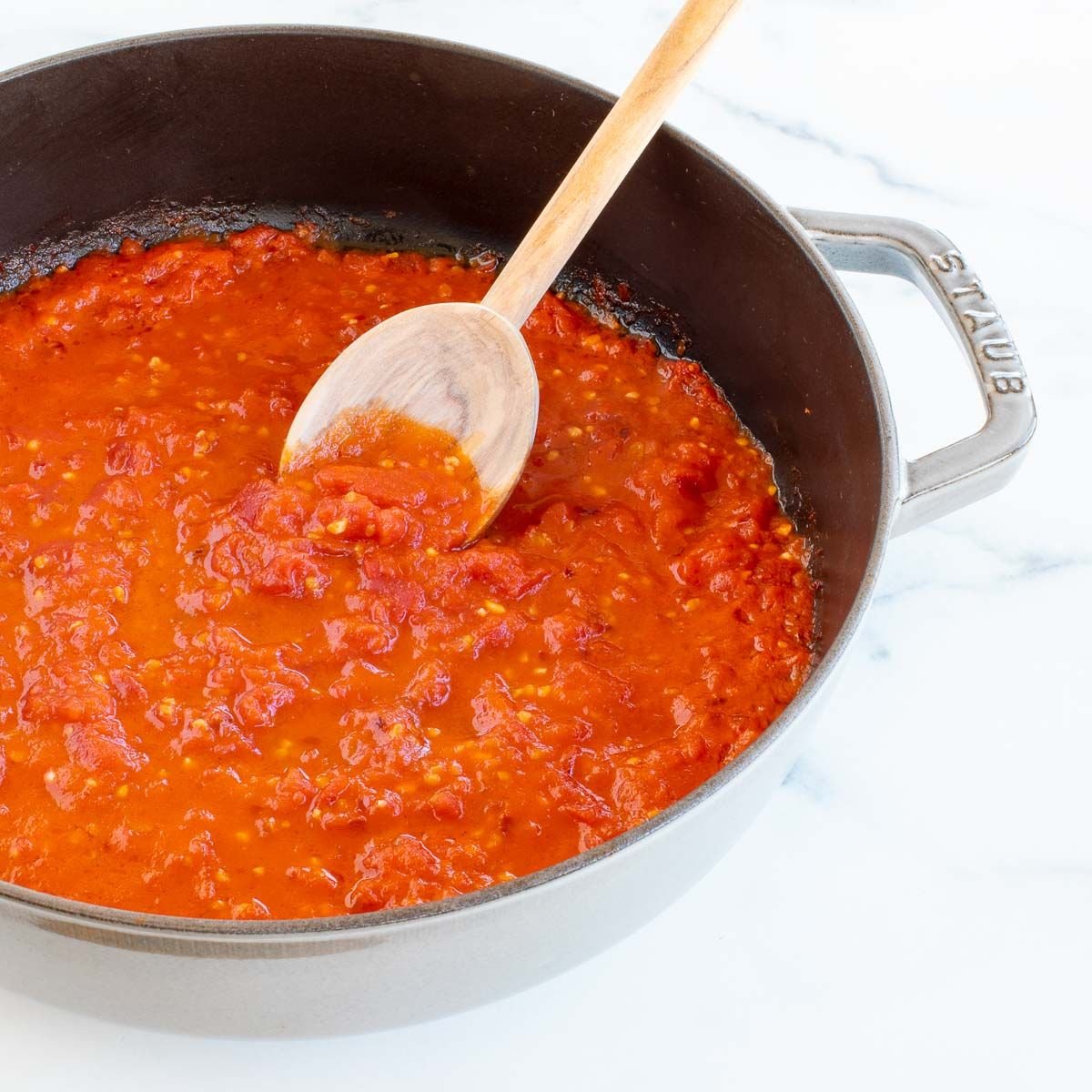 A cast iron pan filled with arrabbiata