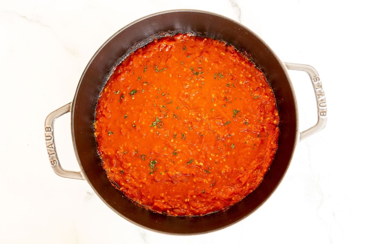 A cast iron pan filled with arrabbiata