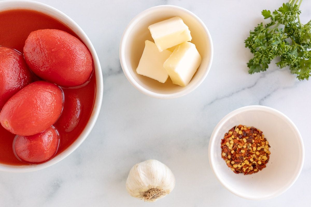 Ingredients for arrabbiata laid out on a marble surface