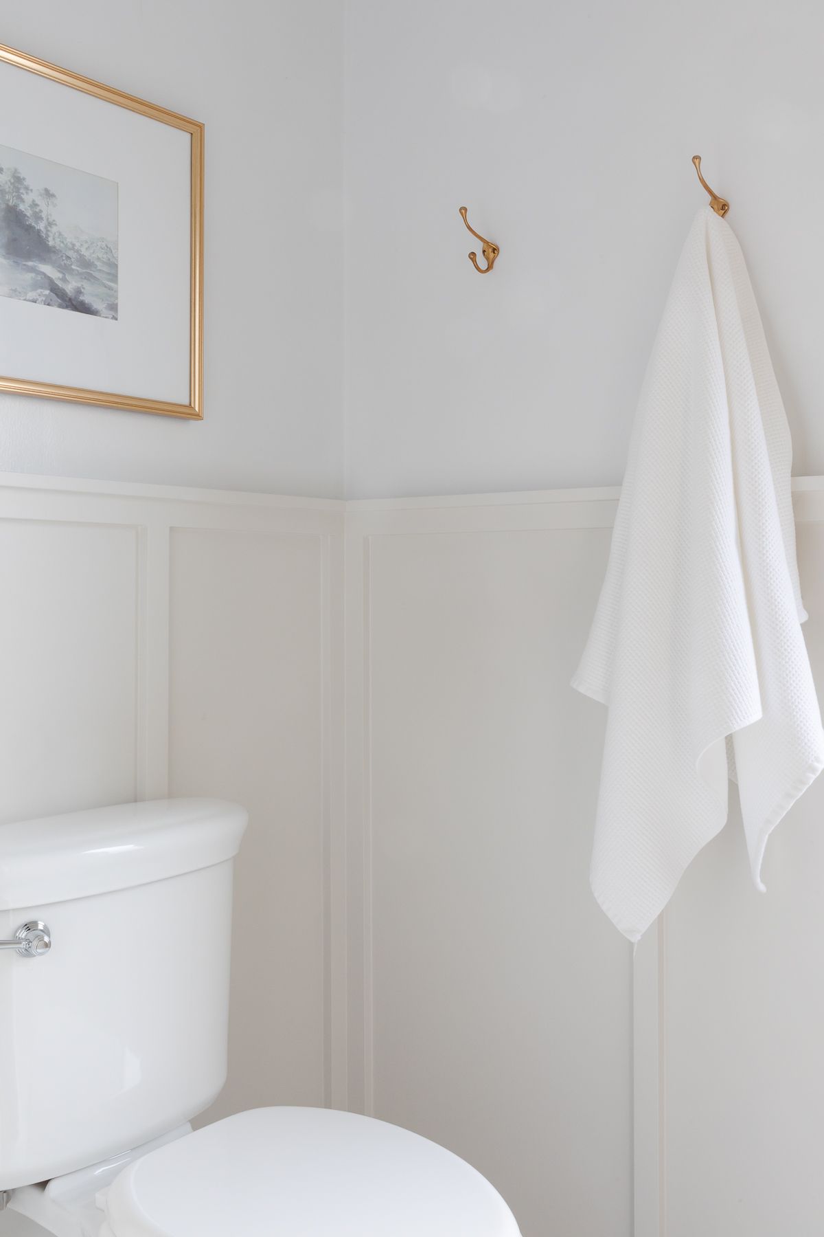 A bathroom with light gray board and batten