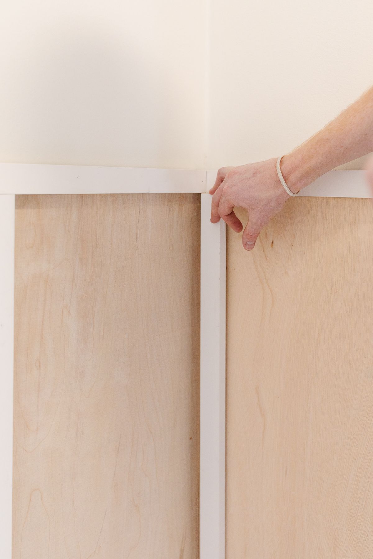 A board and batten wall being installed, prior to paint