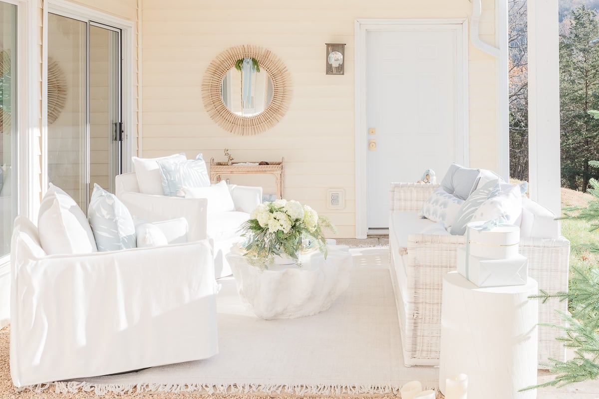 patio with white wicker furniture and slipcovered chairs