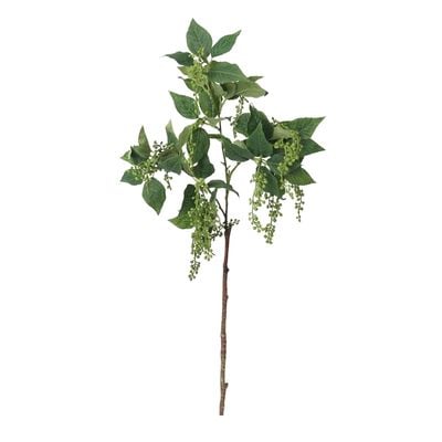 A faux flower greenery branch on a white background.