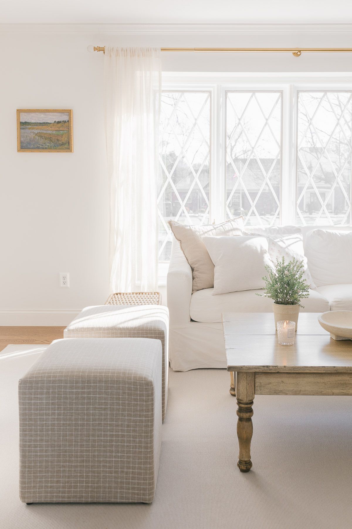 A neutral living room paint color on the walls of a soft neutral living room