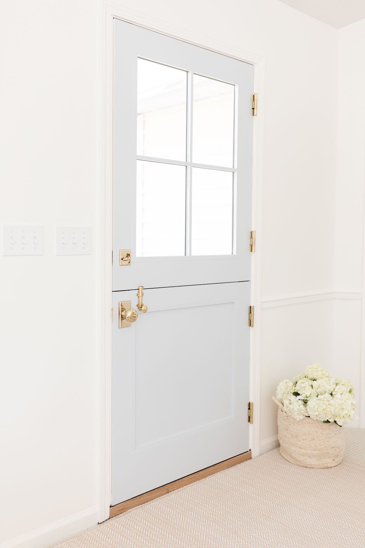 A door into a living room painted in a blue gray paint color