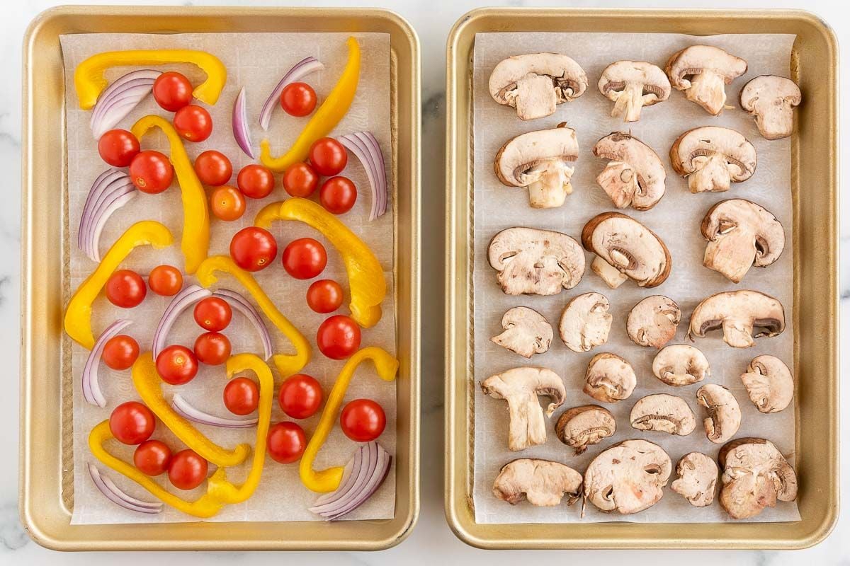 Two sheet pans, one with tomatoes, onions and peppers and one with sliced portobello mushrooms