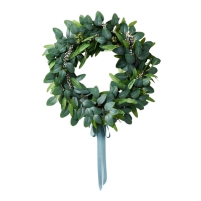 A white wreath adorned with eucalyptus leaves, perfect for year-round front door decoration.