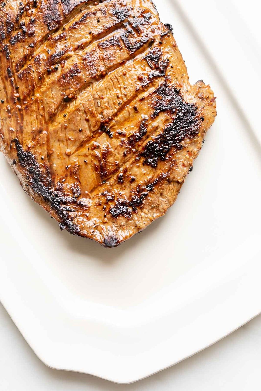 A close up of a cooked piece of carne asada steak.