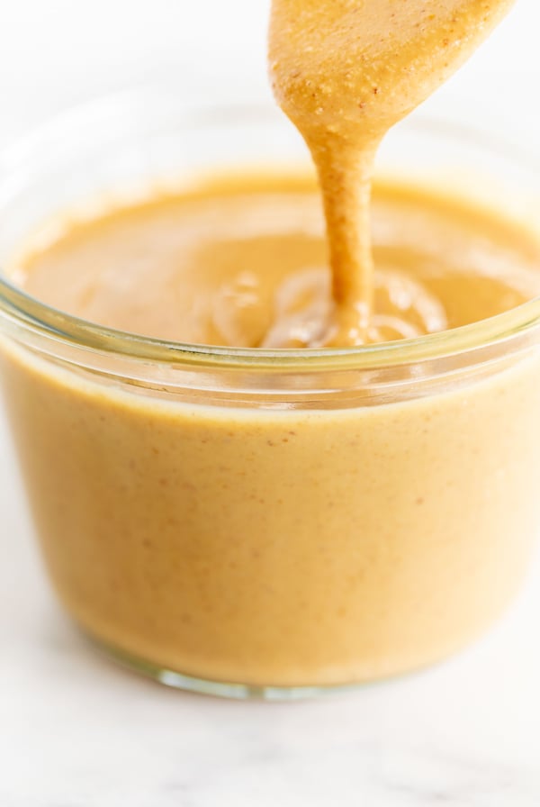 A person is pouring a peanut butter recipe into a bowl for desserts.