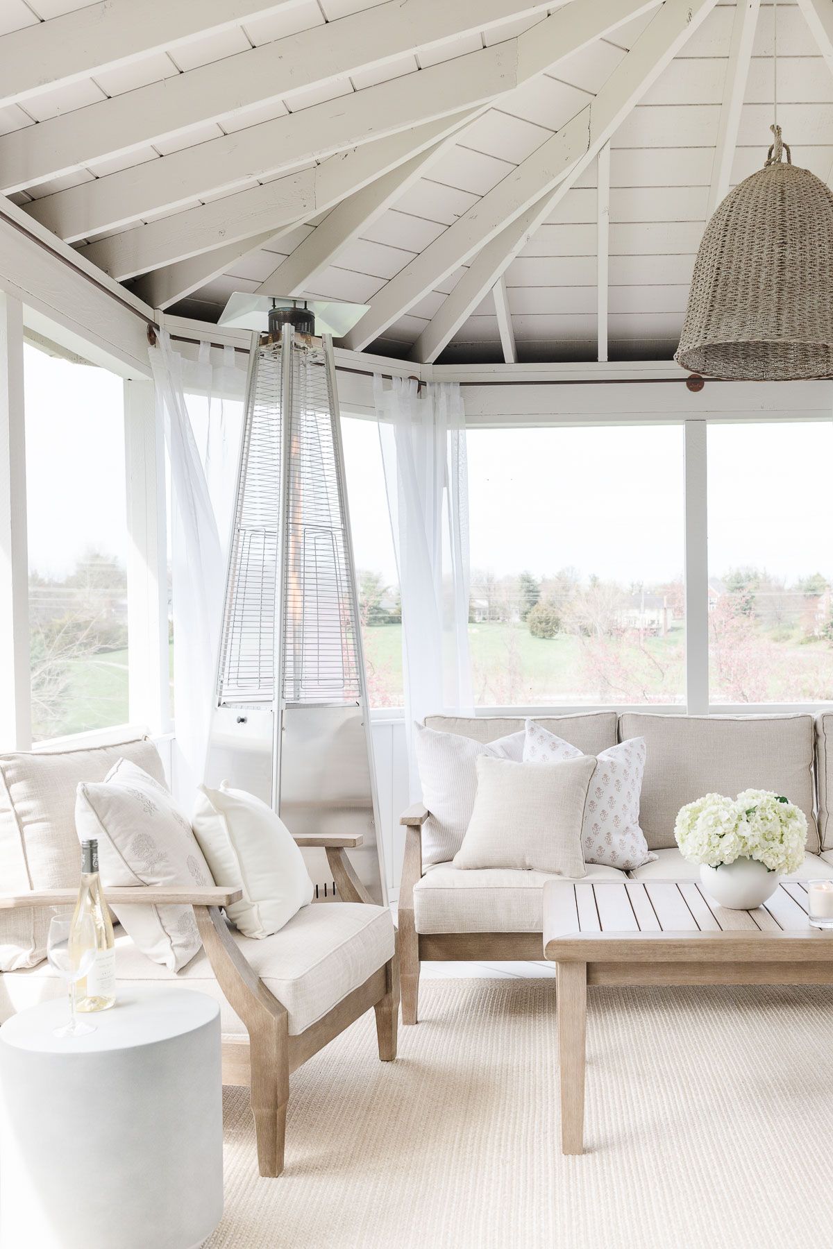 A white screened porch completed with a screened porch kit. 