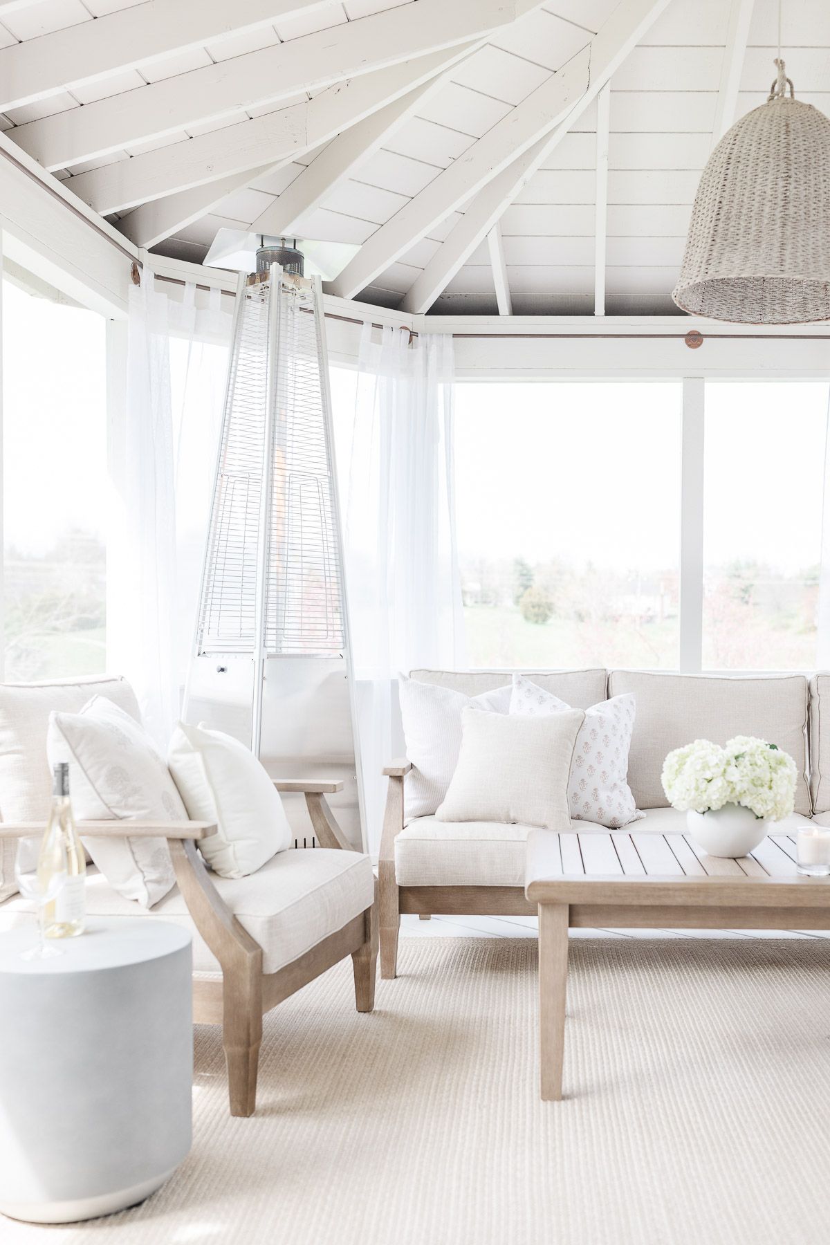 A white screened porch completed with a screened porch kit.