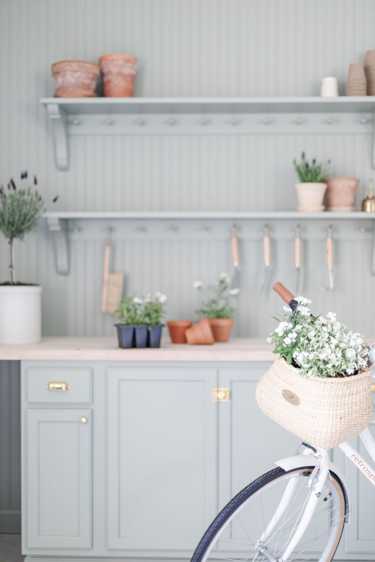 A green built in potting bench painted in Sherwin Williams Evergreen Fog