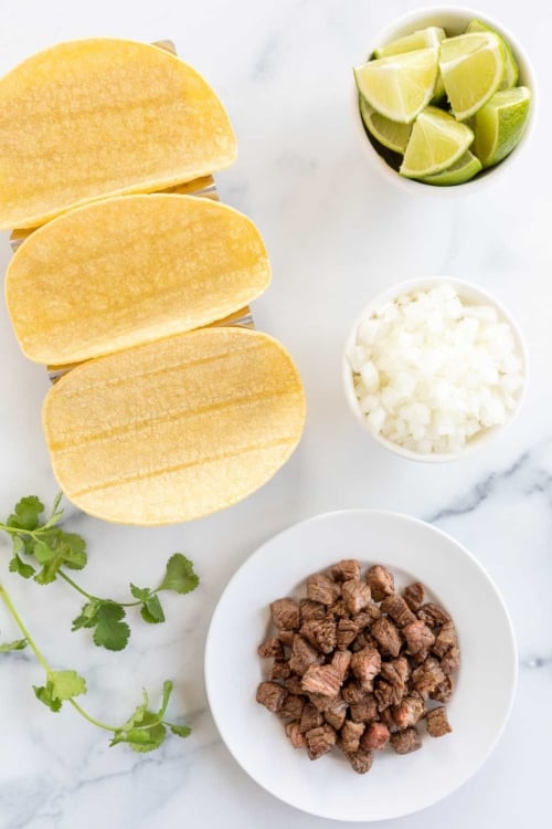 ingredients laid out for street tacos and toppings