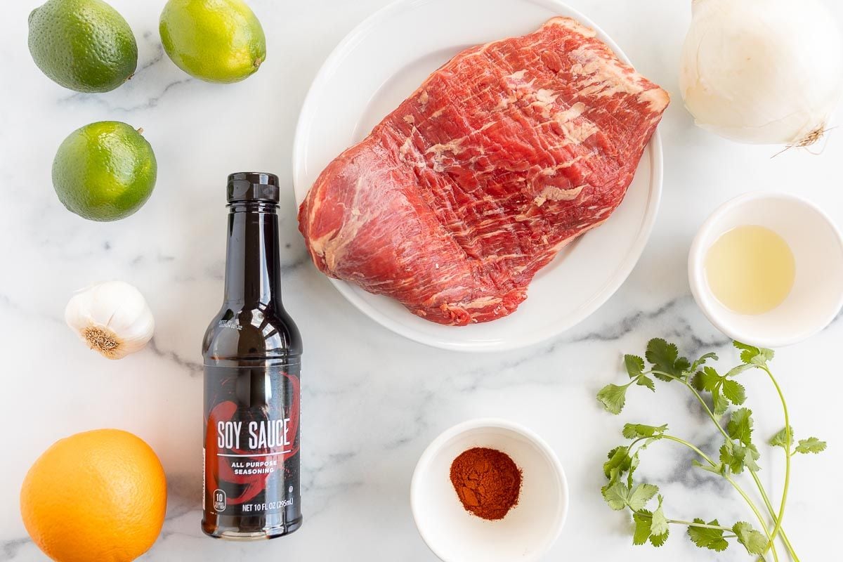 ingredients for street tacos laid out on a marble surface
