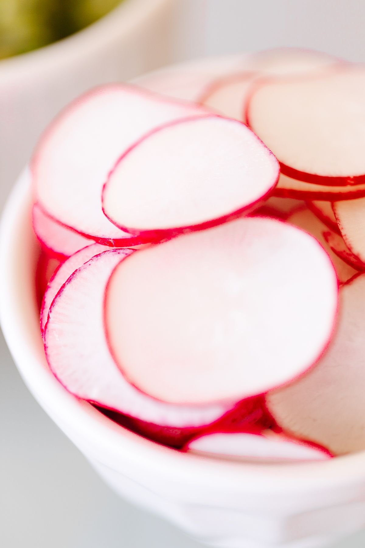 sliced radishes in a white bowl