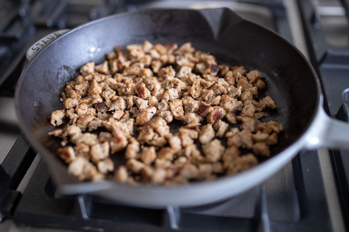 crumbled sausage in a cast iron pan