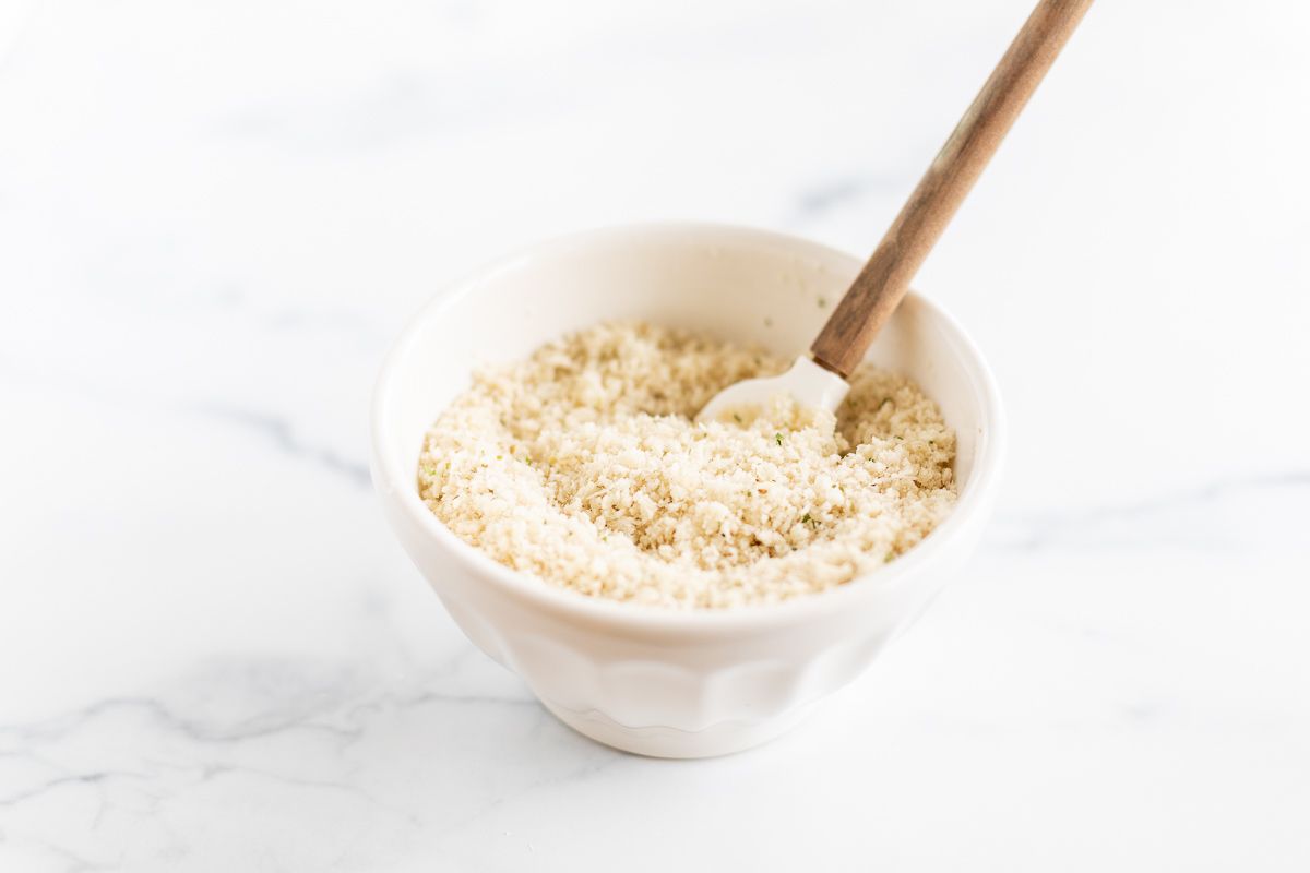 A small white bowl full of panko breadcrumbs