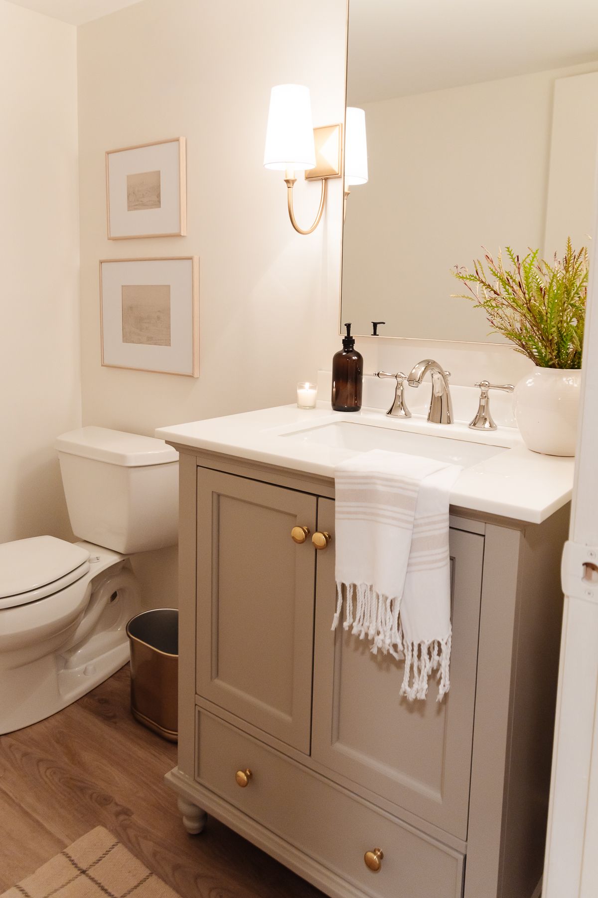 A cream bathroom with a vanity painted in a mushroom paint color