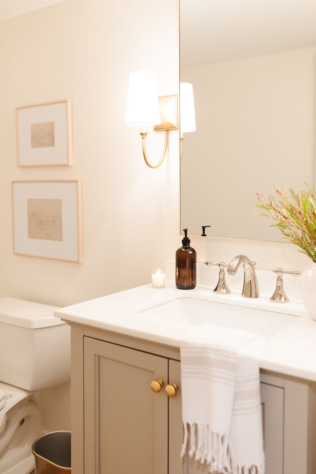 A cream bathroom with a vanity painted in a mushroom paint color