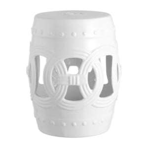 A white ceramic garden stool with a circular design.