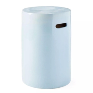 A light blue ceramic garden stool on a white background.