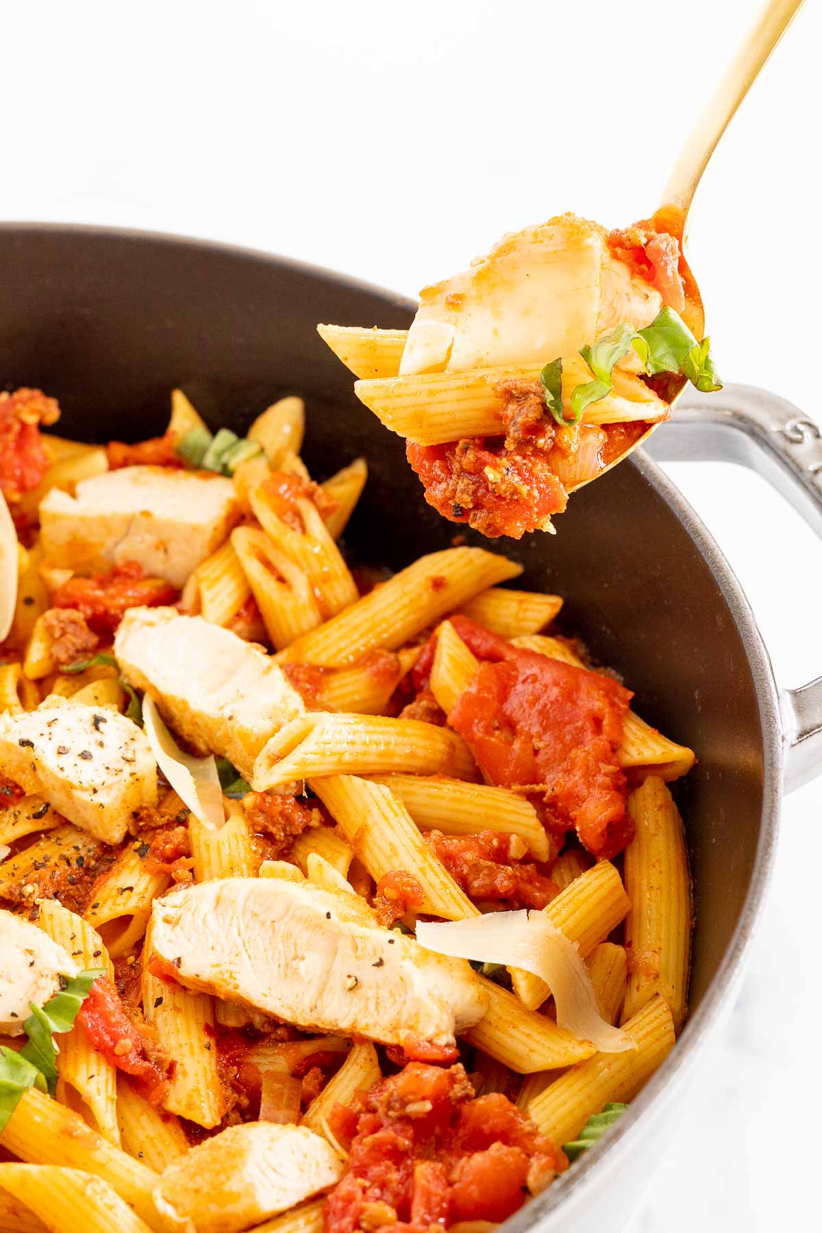 Chorizo and chicken pasta in a cast iron skillet.