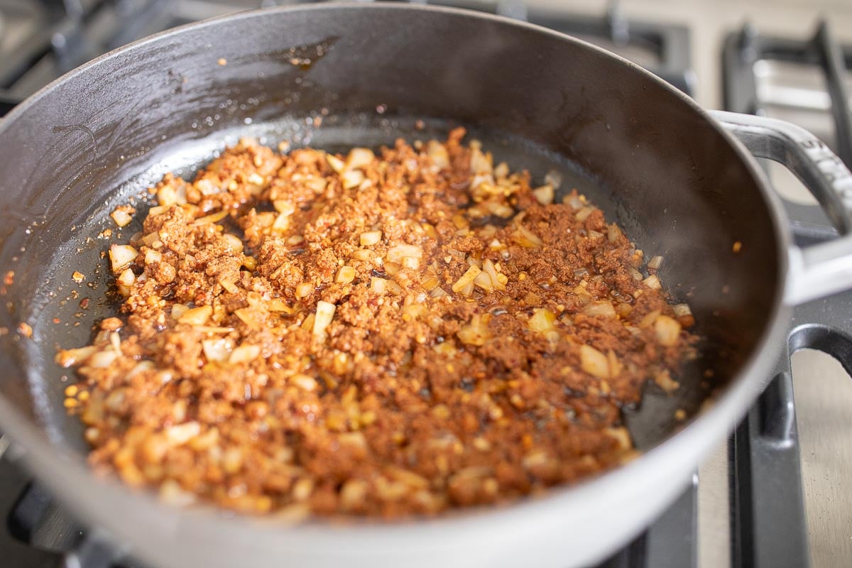 chorizo in a cast iron skillet on a stove top