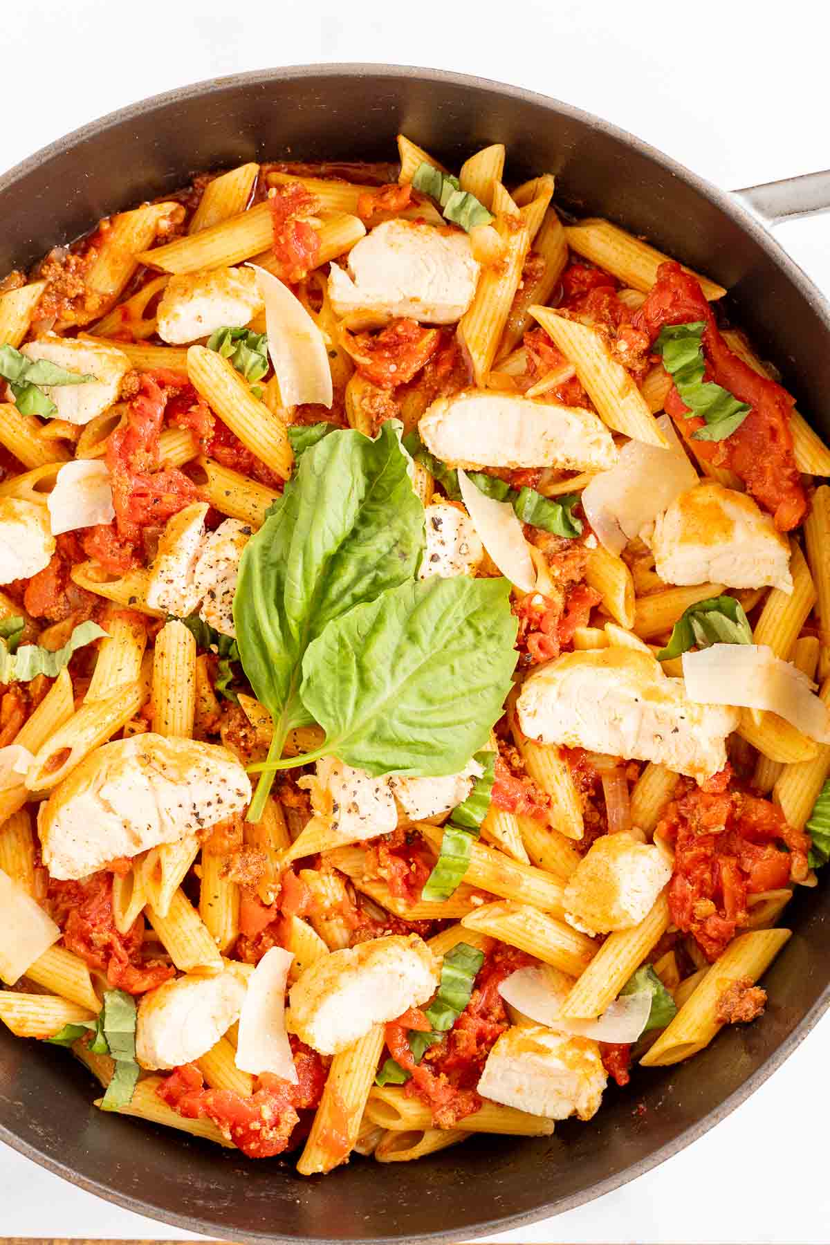 Chorizo and chicken pasta in a cast iron skillet.