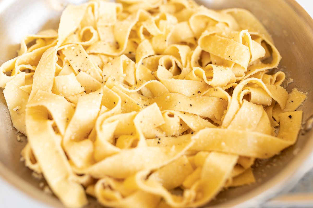 buttered garlic parmesan pasta in a silver pan