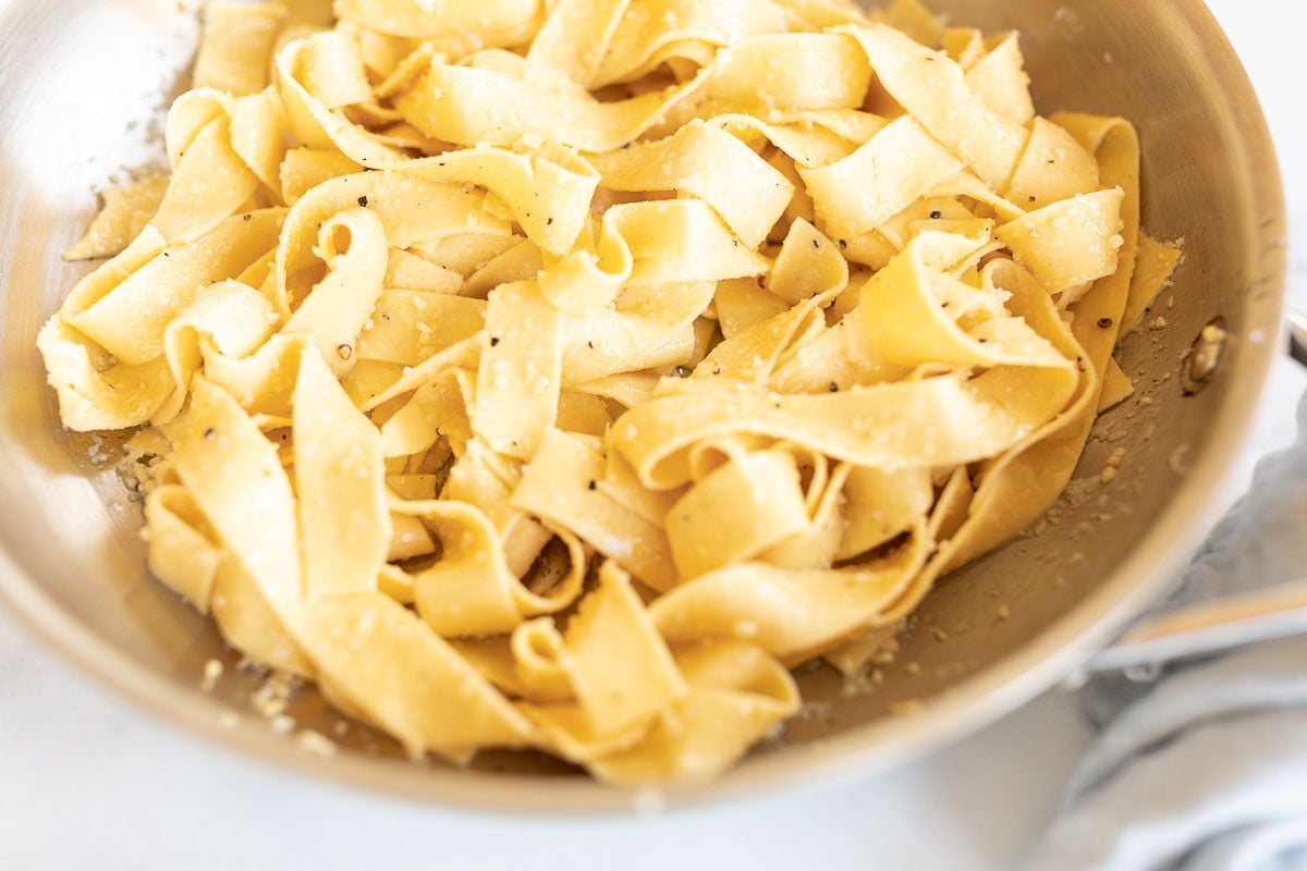 buttered garlic parmesan pasta in a silver pan