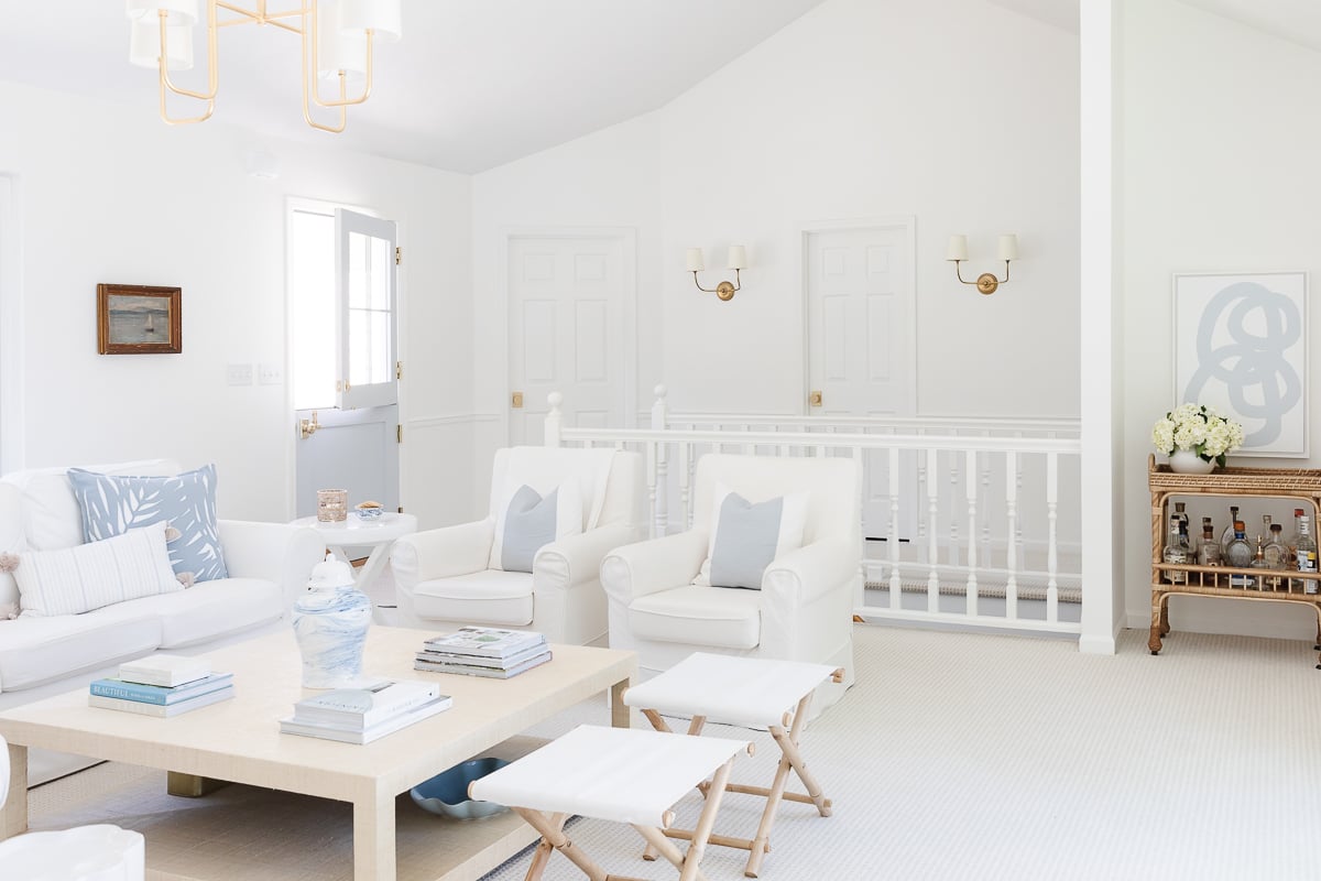 A white coffee table with soft blue and white coffee table decor.