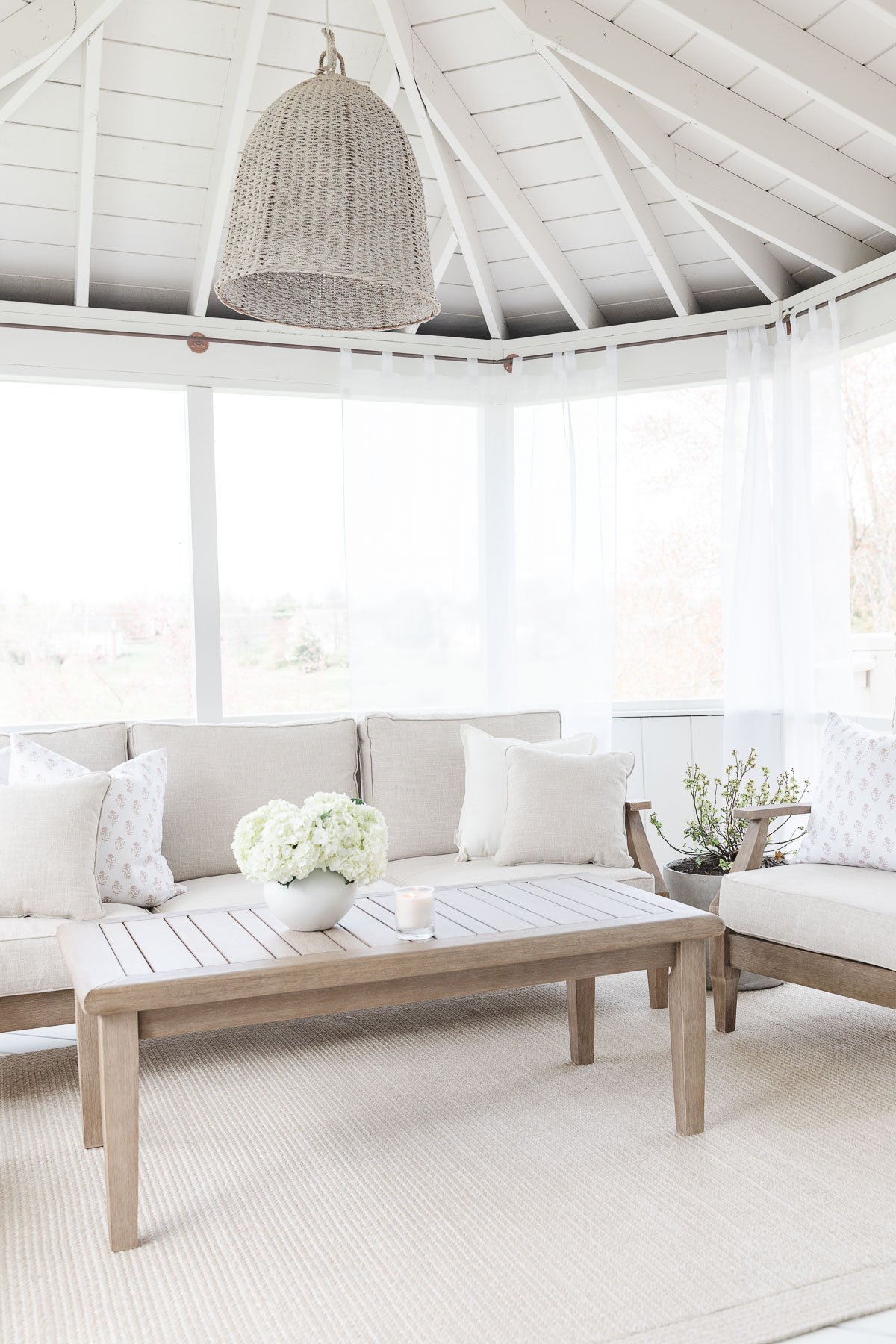 outdoor room with curtains sofa and shairs