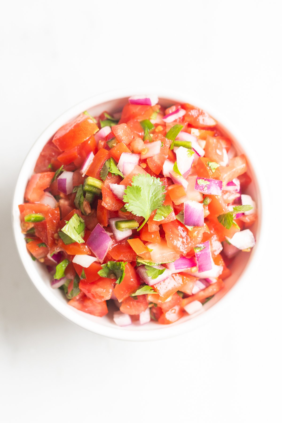 A white bowl of pico de gallo