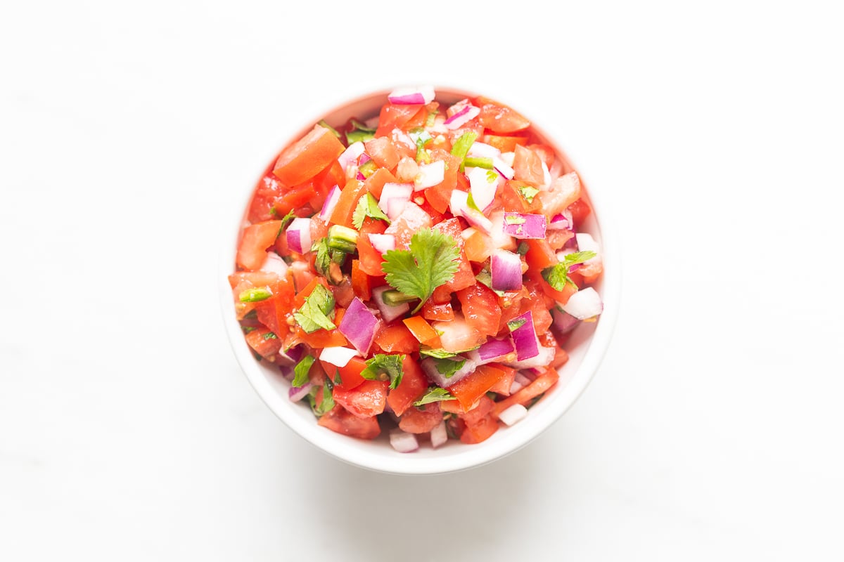 A white bowl of pico de gallo