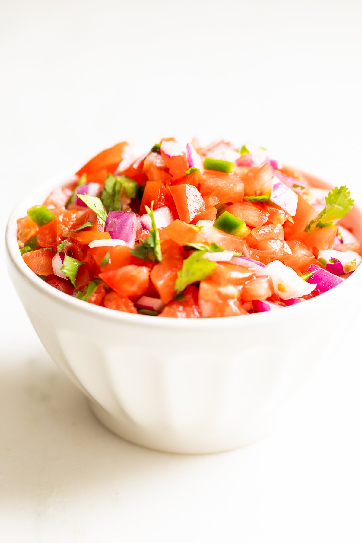 A white bowl of pico de gallo