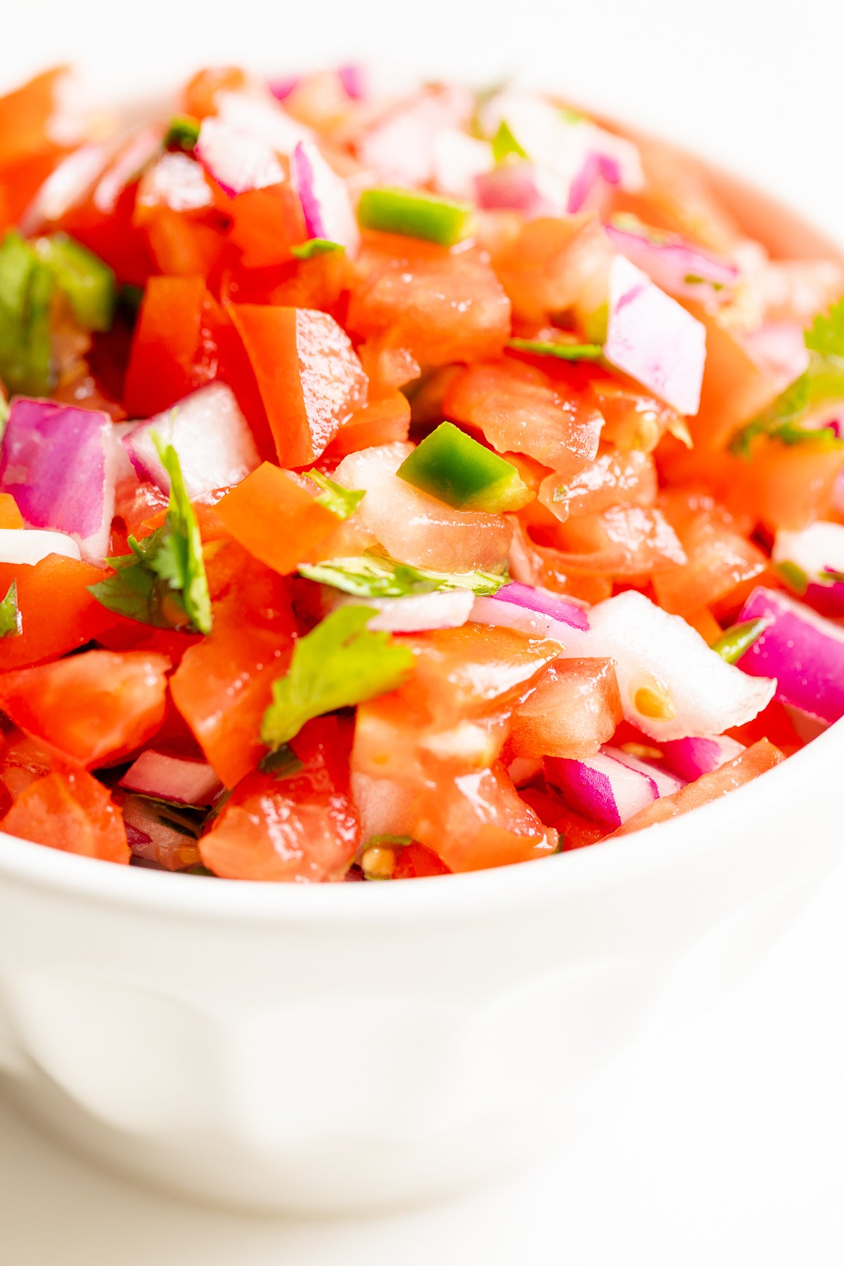 A white bowl of pico de gallo