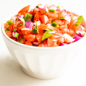 A white bowl of pico de gallo