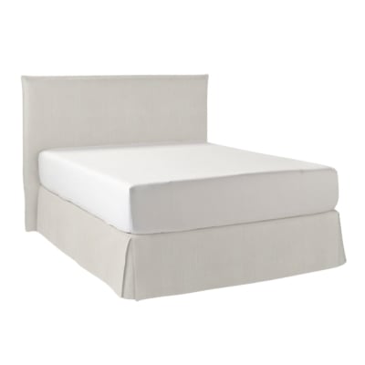 An upholstered bed with a white headboard and footboard.