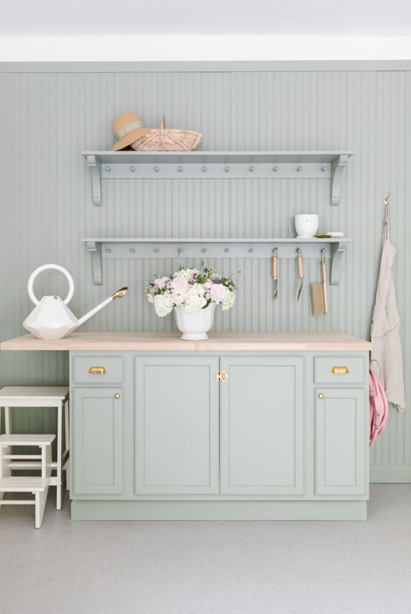 A kitchen with butcher block countertops and shelves.