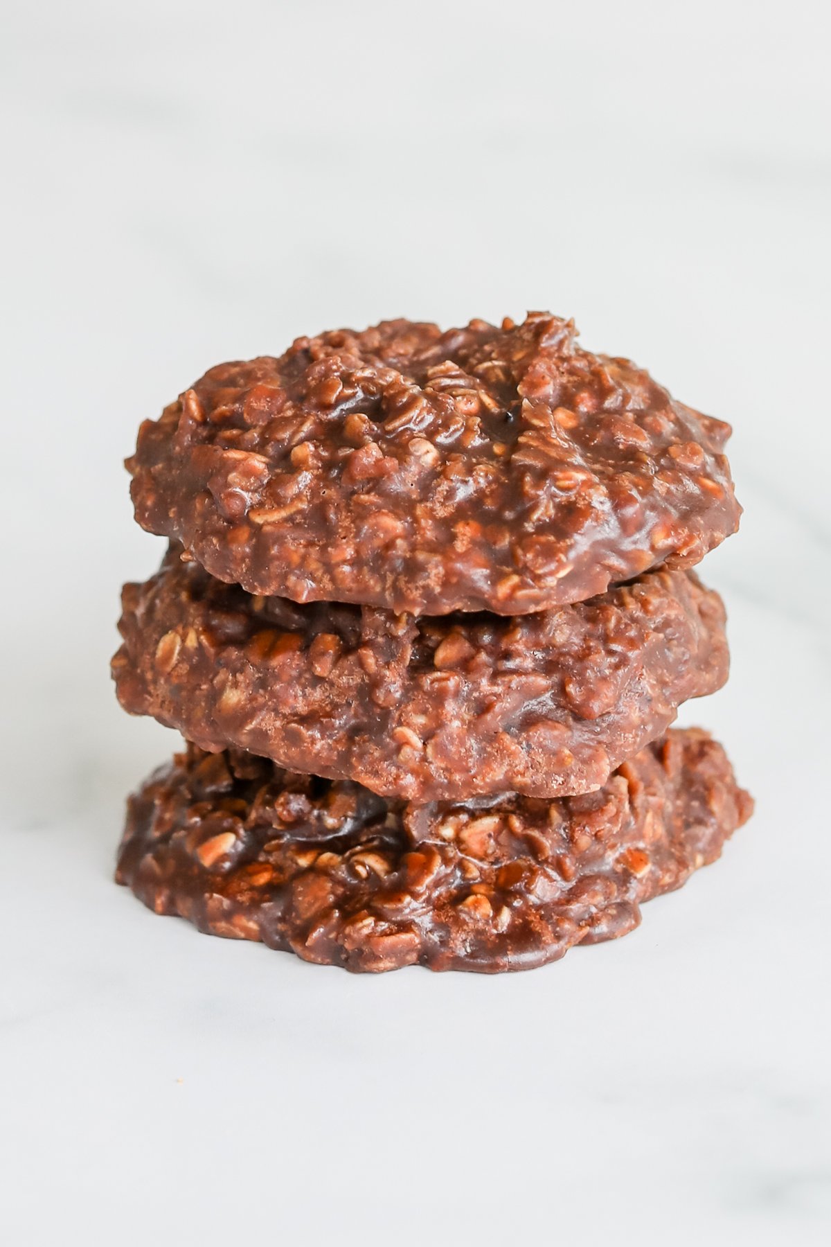 A stack of chocolate no bake desserts on a white surface.