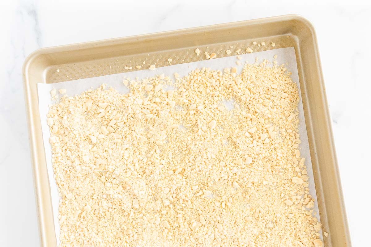 A panko substitute breadcrumb on a gold baking sheet lined with parchment paper