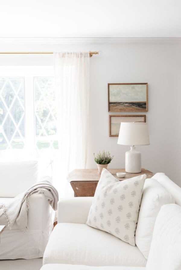 A white living room with a pottery barn slipcovered sofa and chairs.