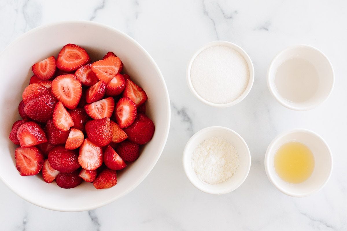 Strawberry crumble filling ingredients on a white surface